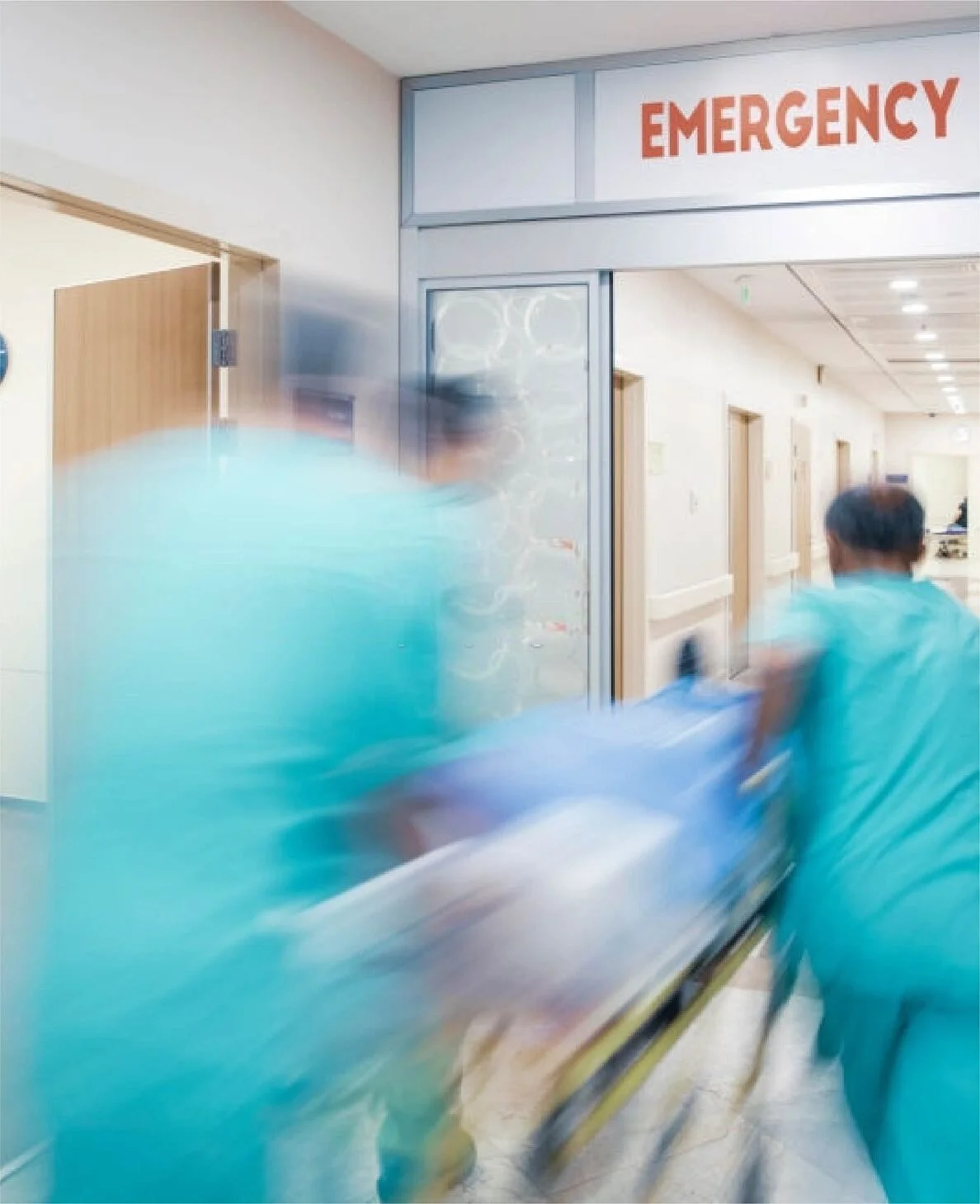 Hospital team moving a patient toward emergency care