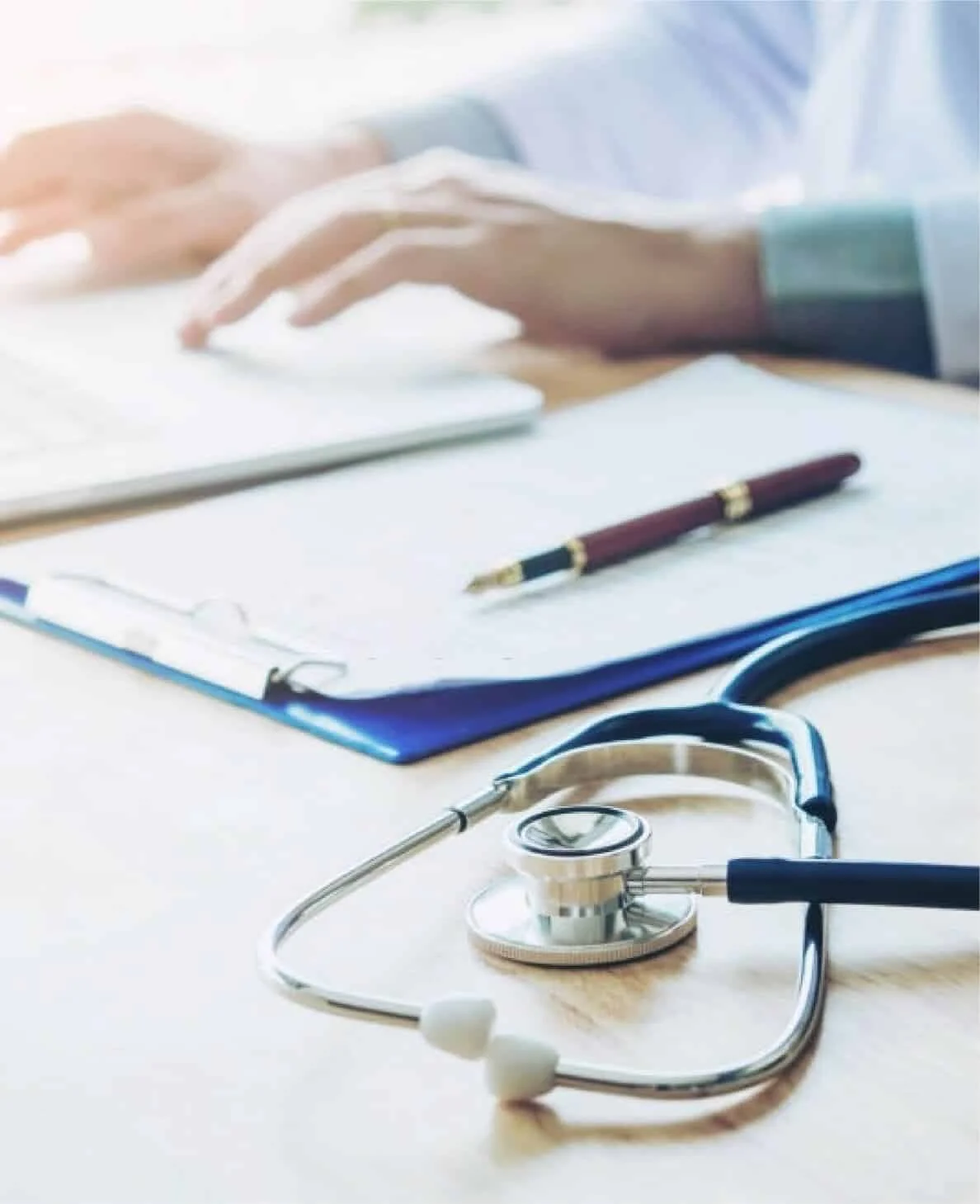 Stethoscope and patient notes on a consultation desk