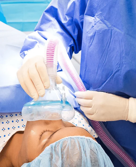 Anaesthesia mask being held over a patient's face