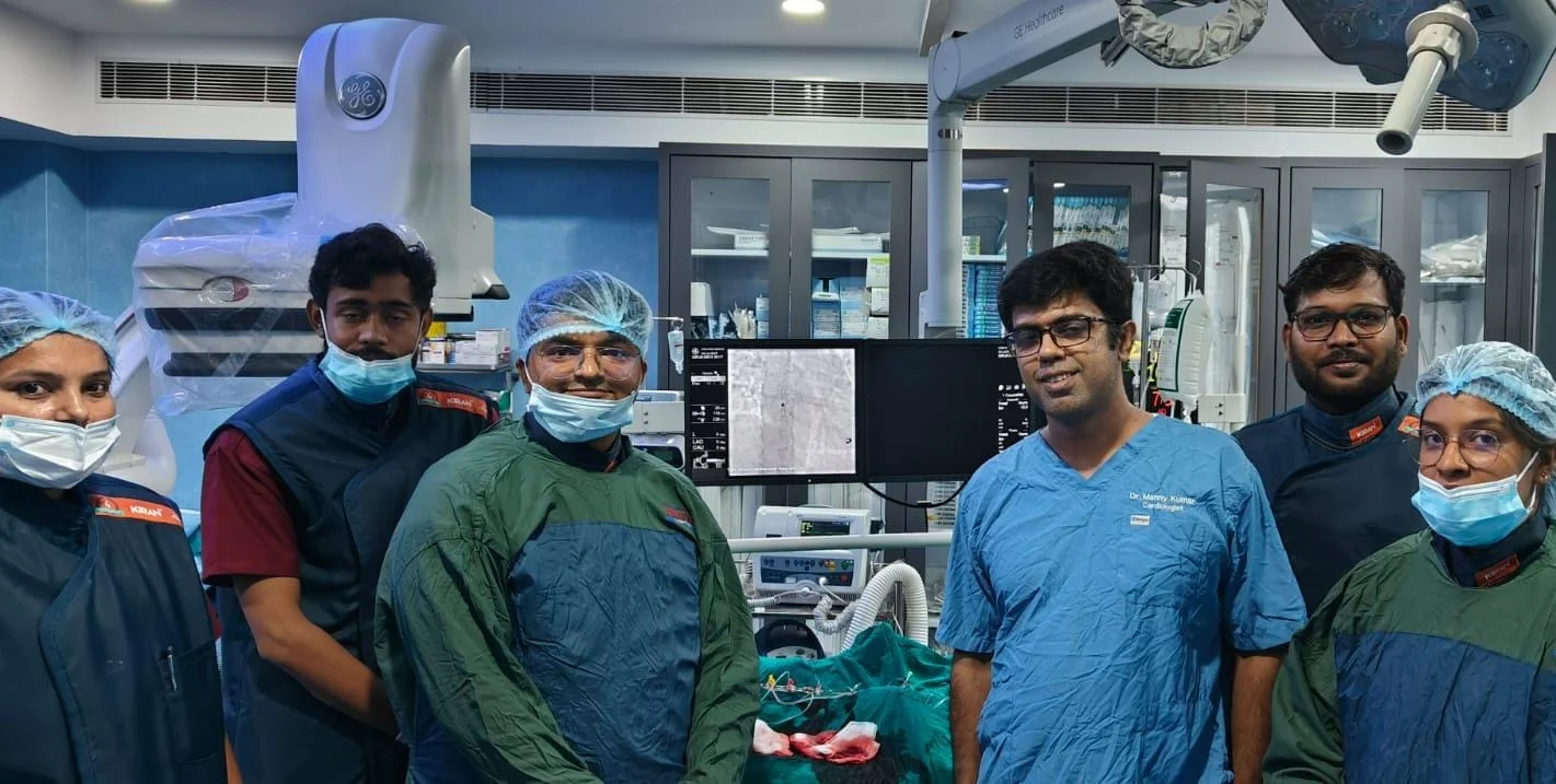 Medical team beside cardiac procedure equipment